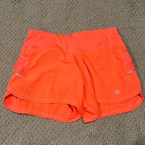 coral athletic shorts from athleta. barley worn
